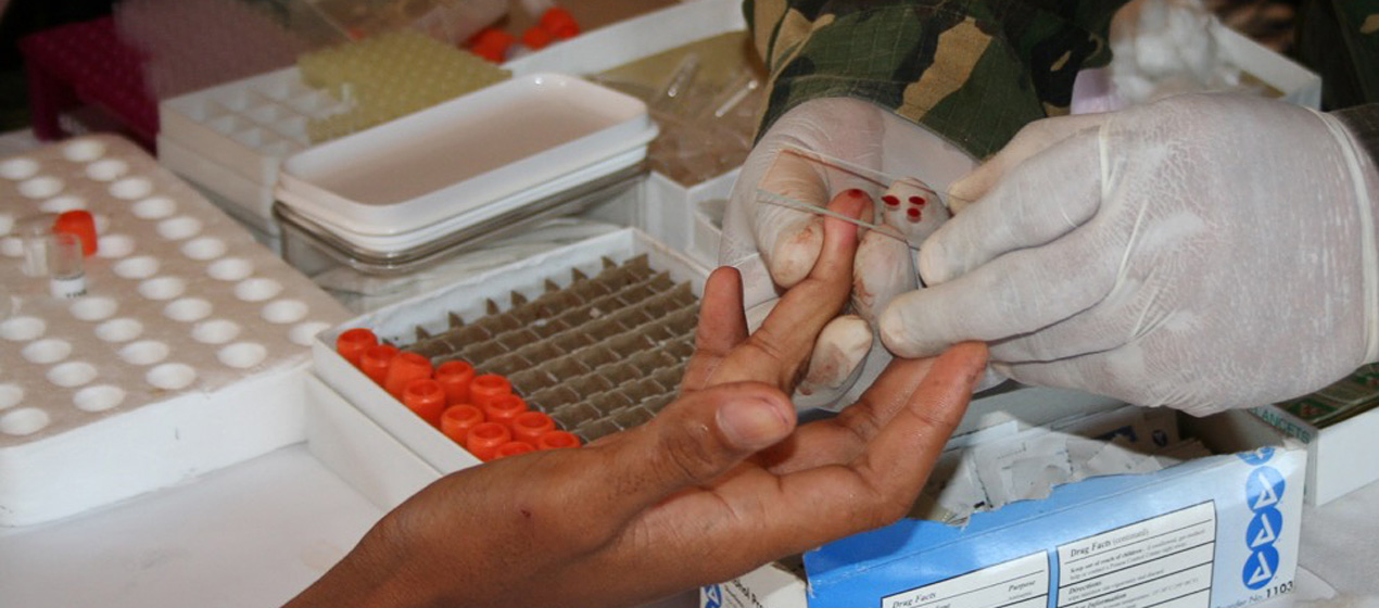 Taking a blood slide to identify malaria infection